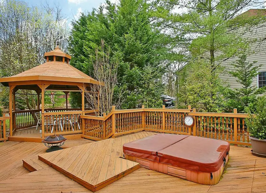 Wood deck with gazebo and spa in backyard of home