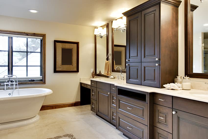 Bathroom with pedestal tub and custom cabinet vanities