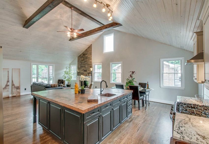 Beautiful luxury kitchen with reclaimed wood counter island and vaulted ceiling