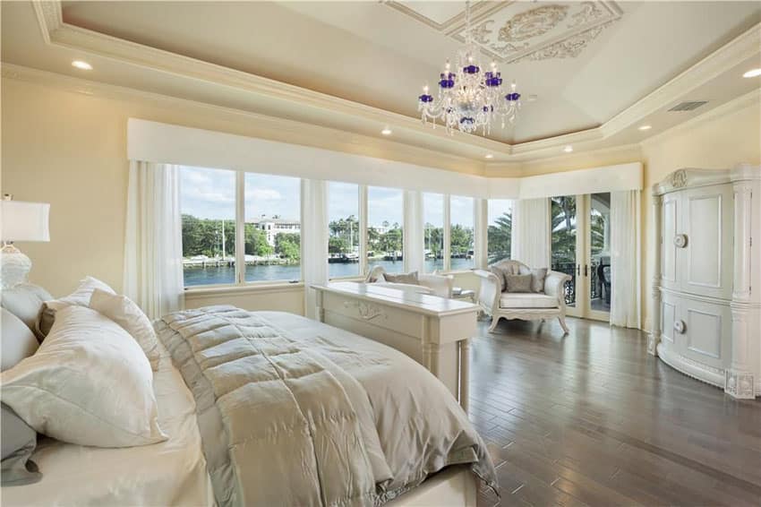 Beautiful master bedroom with white furniture wardrobe and canal views