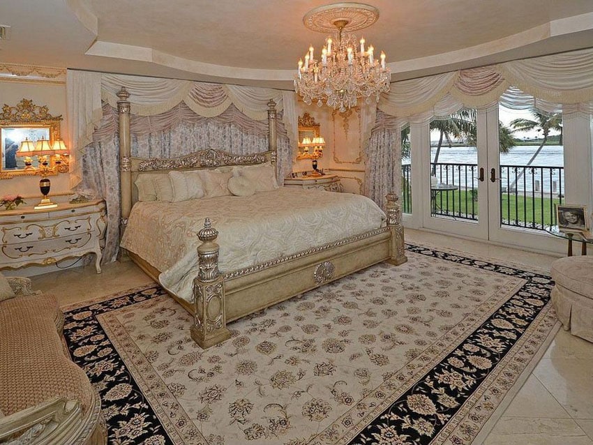 Bedroom with decorative bed french provincial furniture, chandelier and water front views