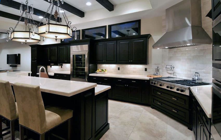 Contemporary kitchen with dark cabinets limestone floors and breakfast bar island