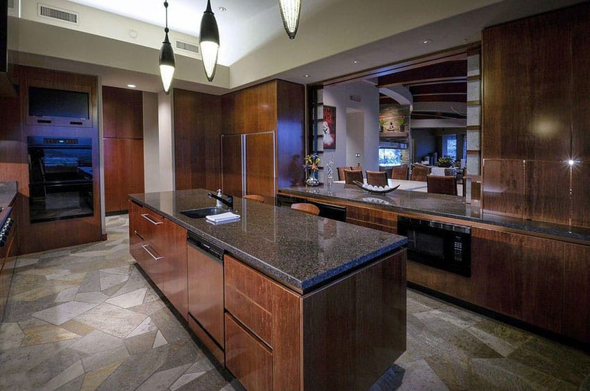 Contemporary kitchen with dark European style cabinets and dark honed granite counters