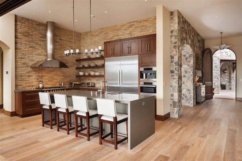 Kitchen with gray graphite counters, large island and brick veneer walls