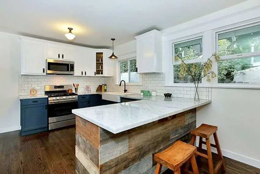 Kitchen with wood peninsula and white subway tiles