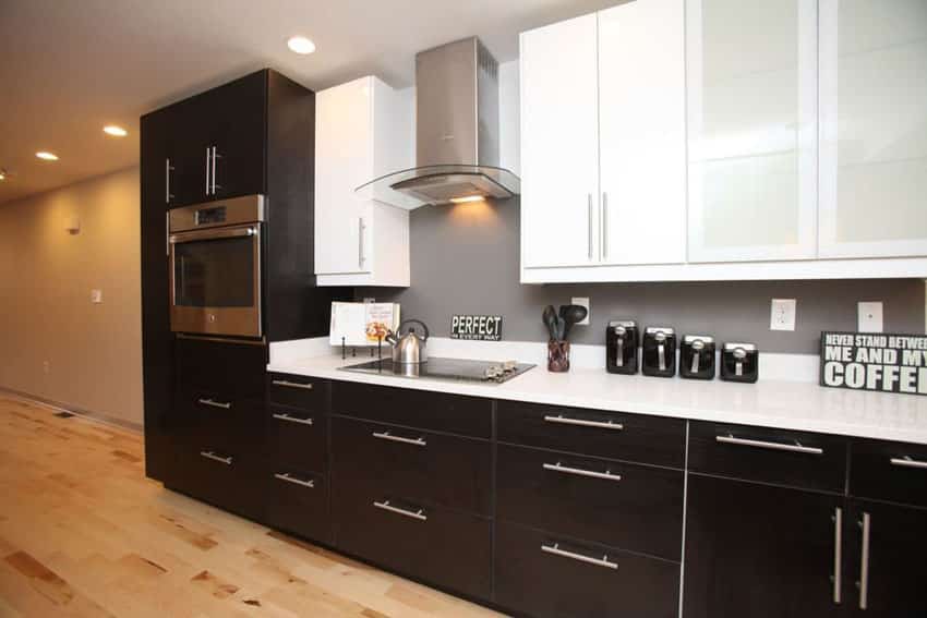 Contemporary one wall kitchen with arctic white quartz countertops and black and white cabinets