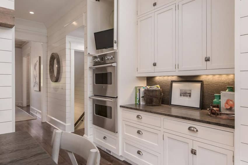 Cottage kitchen with white shaker cabinets and grey marble backsplash