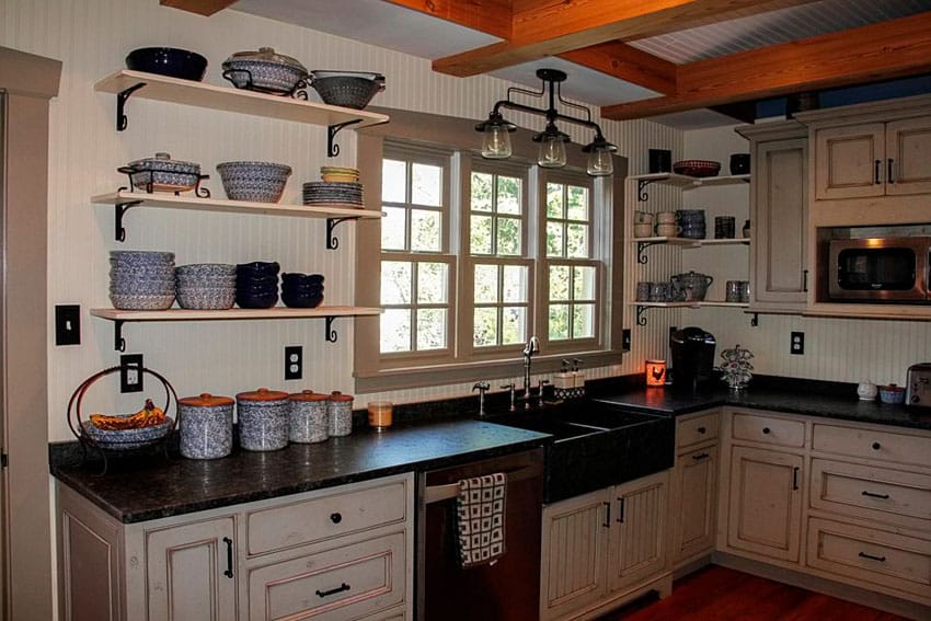 Country kitchen with black basin farmhouse sink, open shelving and rustic cabinetry