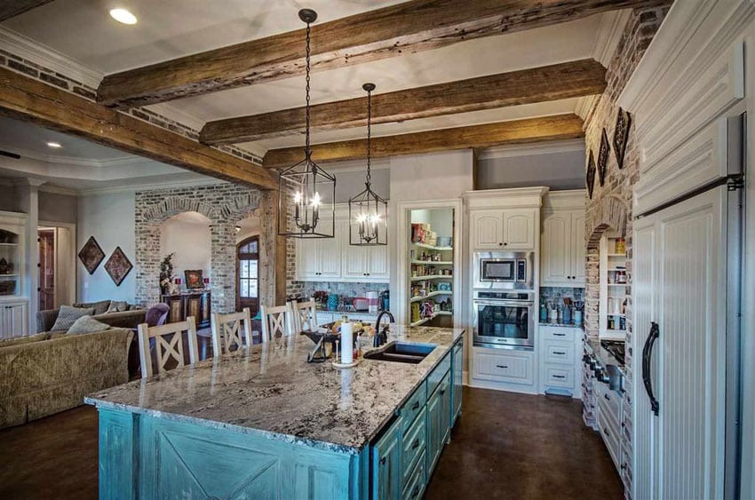 Country style kitchen with painted blue island, porcelain tile floors and granite island