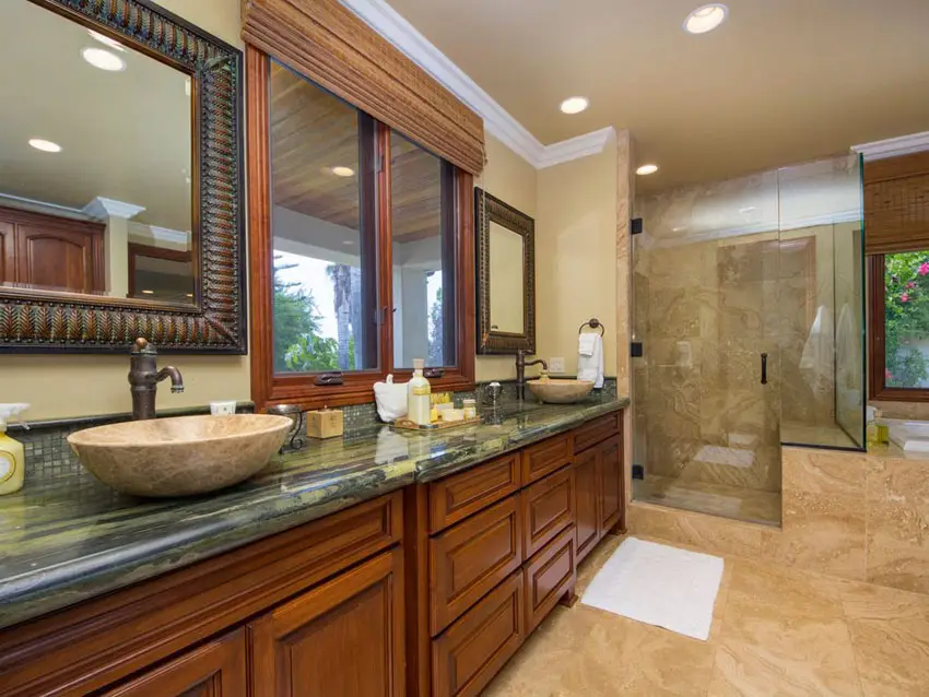 Craftsman bathroom with bright wood vanity, green granite and porcelain tile floors