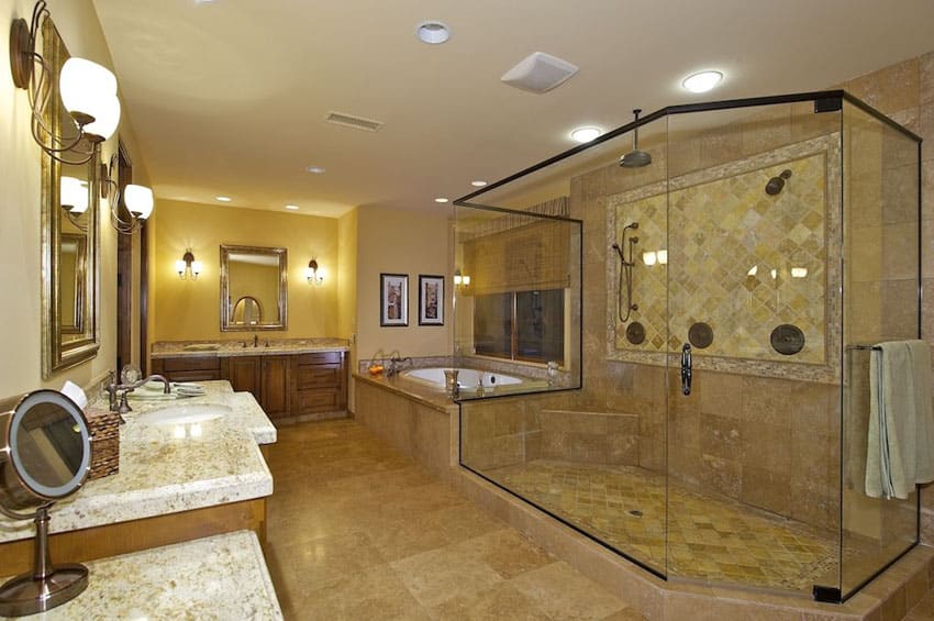 Bathroom with bronze frame shower, travertine tile and fruitwood cabinetry