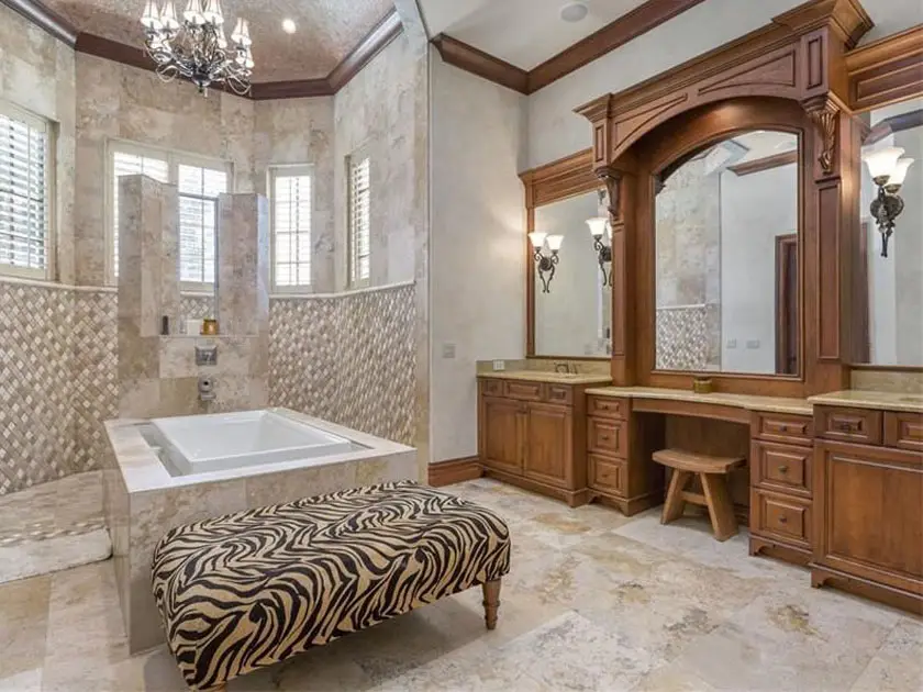 Craftsman bathroom with custom wood vanity, large mirror, porcelain tile floors and enclosed tub 