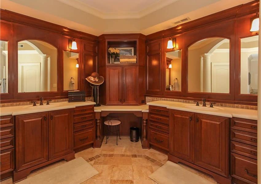 Craftsman bathroom with rich wood vanities, large mirrors and makeup sitting area