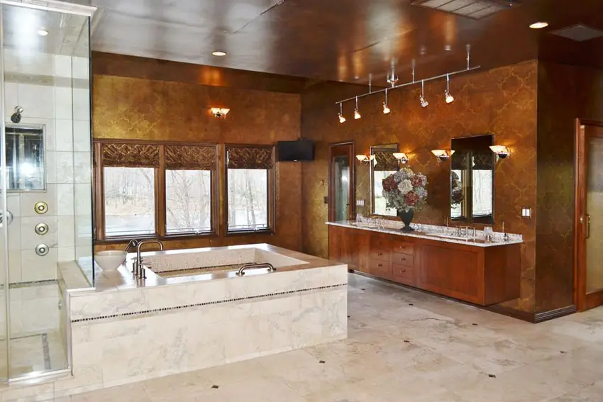 Craftsman bathroom with suspended cabinets, tub enclosure and contemporary track lighting