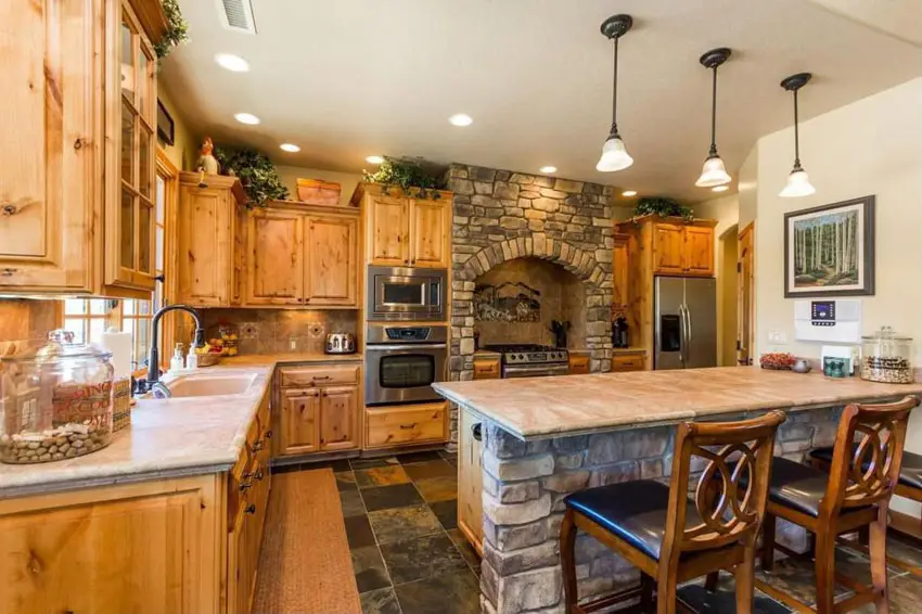Kitchen with limestone counter island and custom stone oven surround