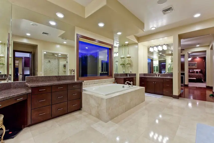 Craftsman master bathroom with red granite counters and travertine floors