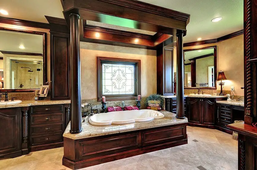 Craftsman master bathroom with wood pillar around enclosed bathroom and decorative wood vanities with dual sinks