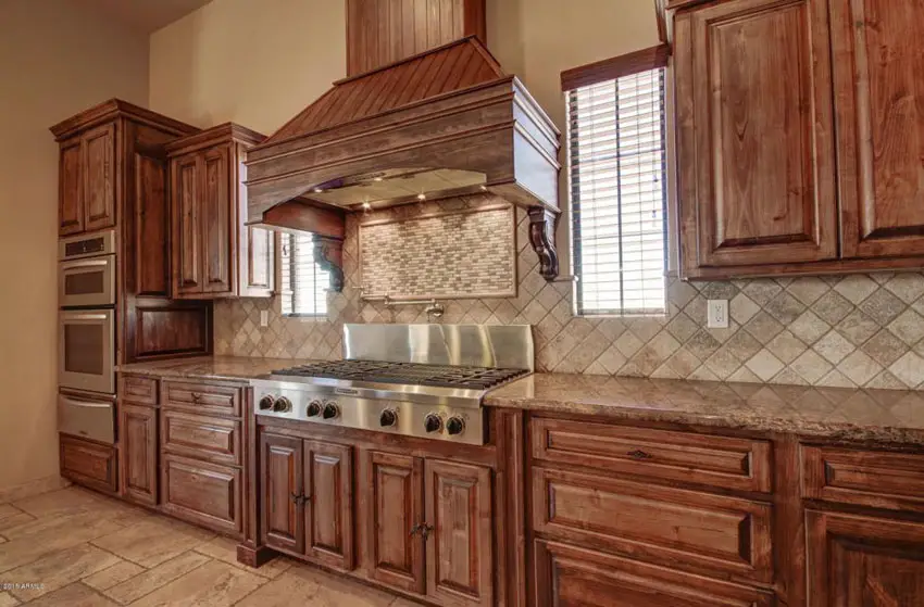 Kitchen with wood cabinets and diagonal square tiles for the backsplash