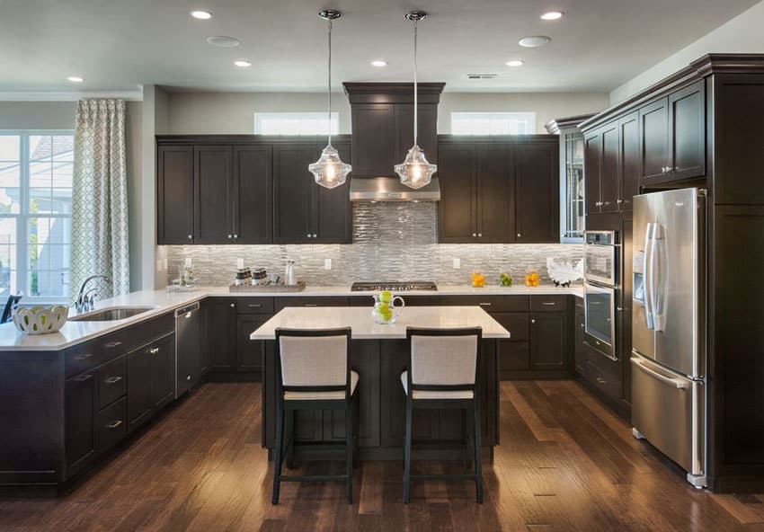 U shaped kitchen design, white countertops and dark finish kitchen cabinets