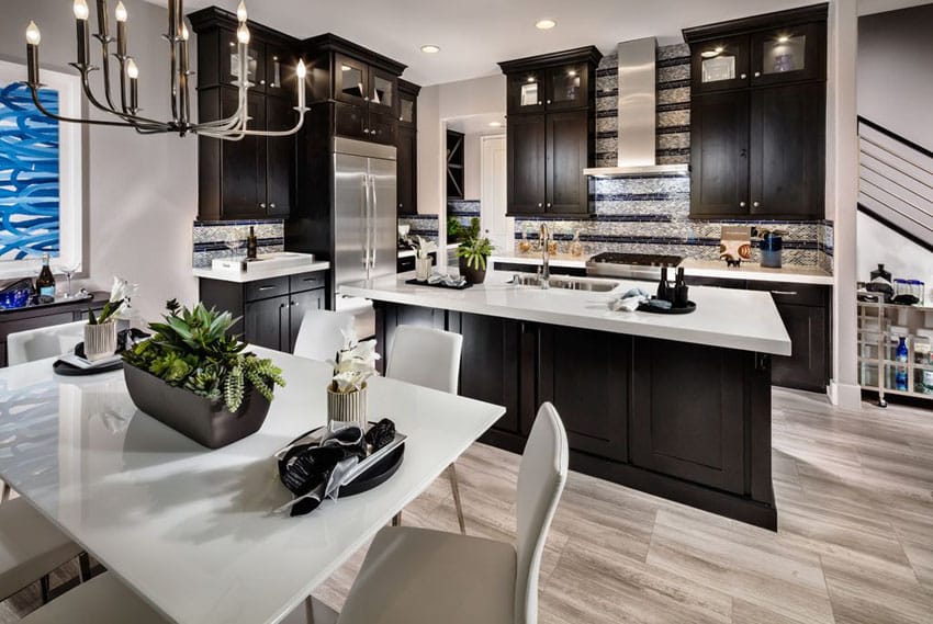 Dark Cabinet Kitchen With White Super Thassos Glass Countertop And Light Wood Floors 