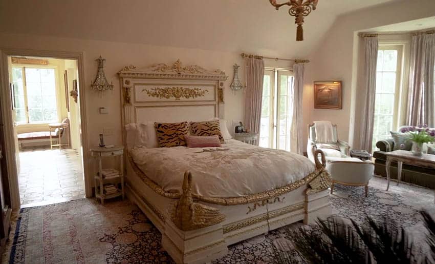 French provincial bedroom design with french doors and gold gilded bed