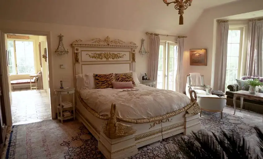 Bedroom design with french doors and gold gilded bed