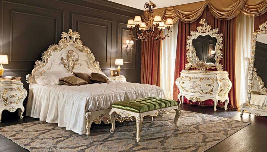French provincial bedroom with elegant white dressers, bed frame and mirror with gold gilding