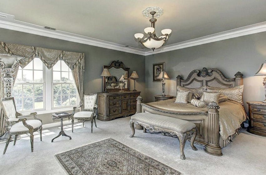 Bedroom with intricate furniture pieces and decorative wood bed