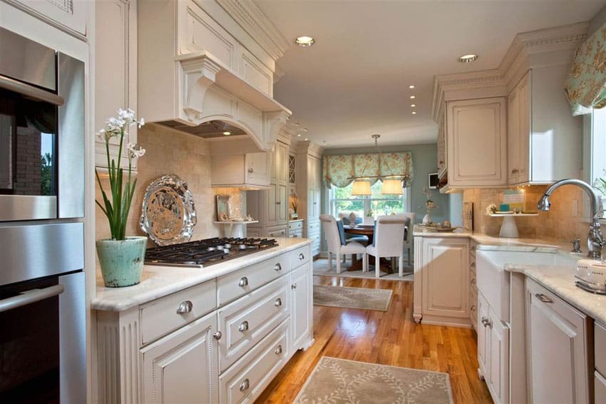 Galley style farmhouse kitchen with basin sink white cabinets and wood floors
