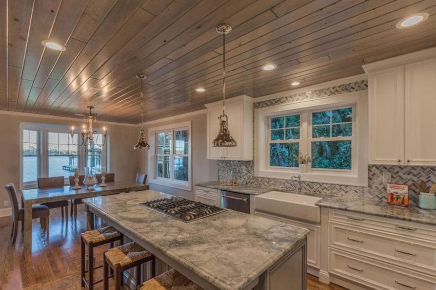 Kitchen with island with built in cooktop and wood plank ceiling