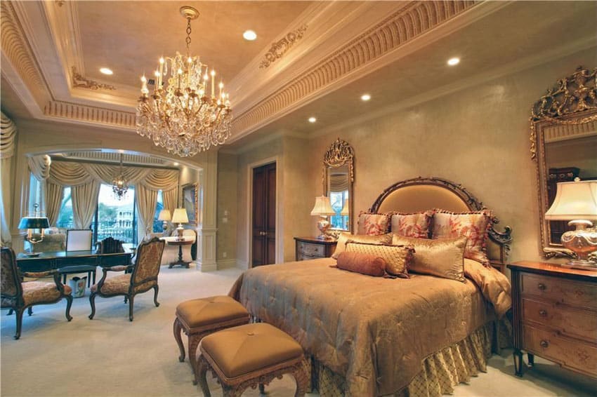Decorated master bedroom with vintage French furniture, tray ceiling, molding, and chandelier