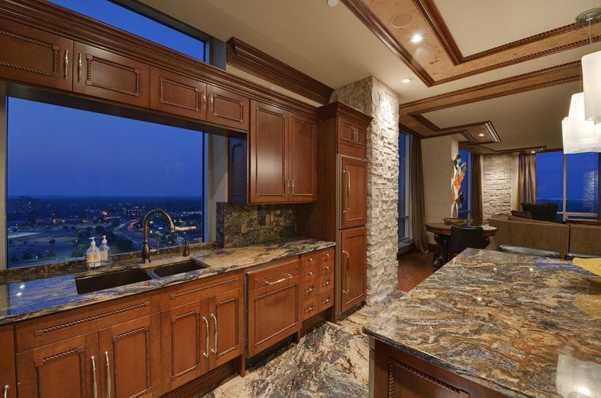 Kitchen with thunder wave granite, column with cladding and picture window