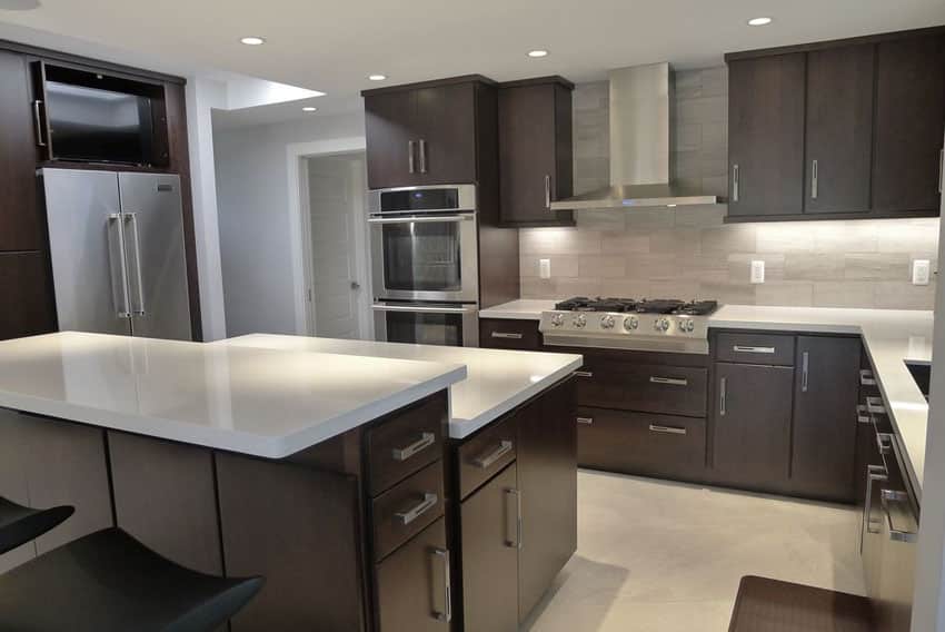 modern dark cabinet and white counter kitchen with porcelain tile floors