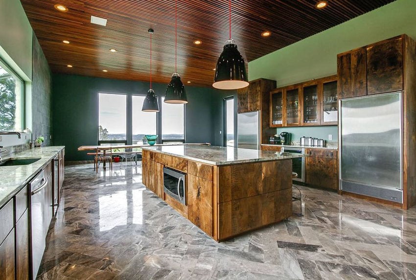 Kitchen with marble floor tiles, wood ceiling and large pendant lights