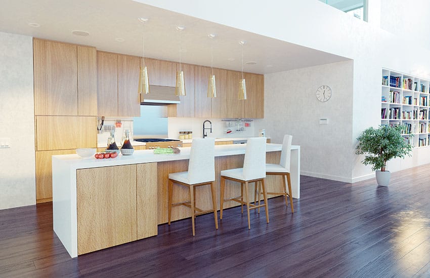 Kitchen with open layout, flushed cabinetry and bar chairs with leather seats