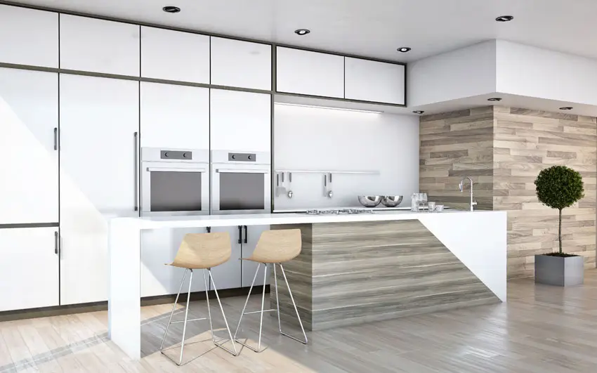 White kitchen cabinets with vertical wall tiles