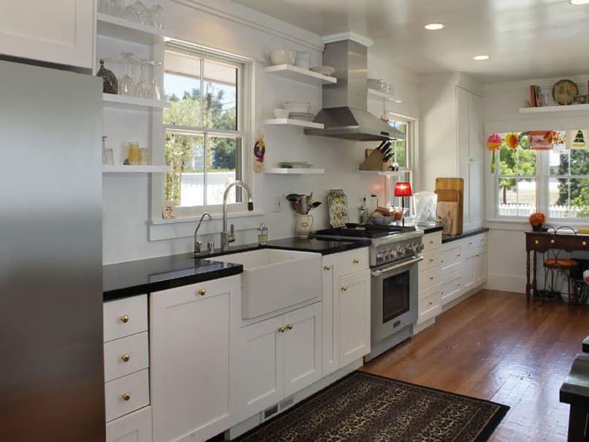 One wall kitchen with white shaker cabinets, farmhouse sink, hardwood floors and arabian black granite counter