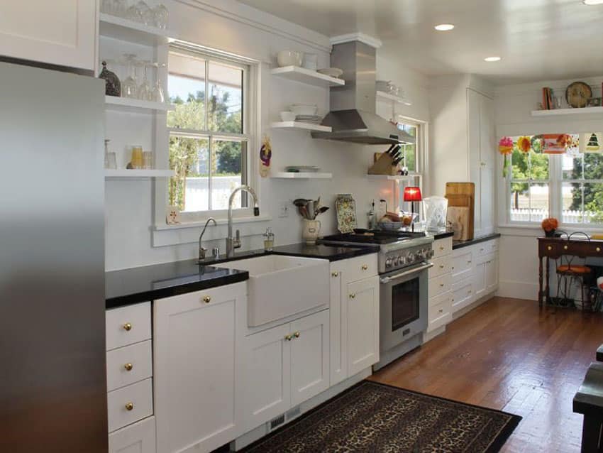 Kitchen with stainless steel cabinets, open shelving and dark brown rug