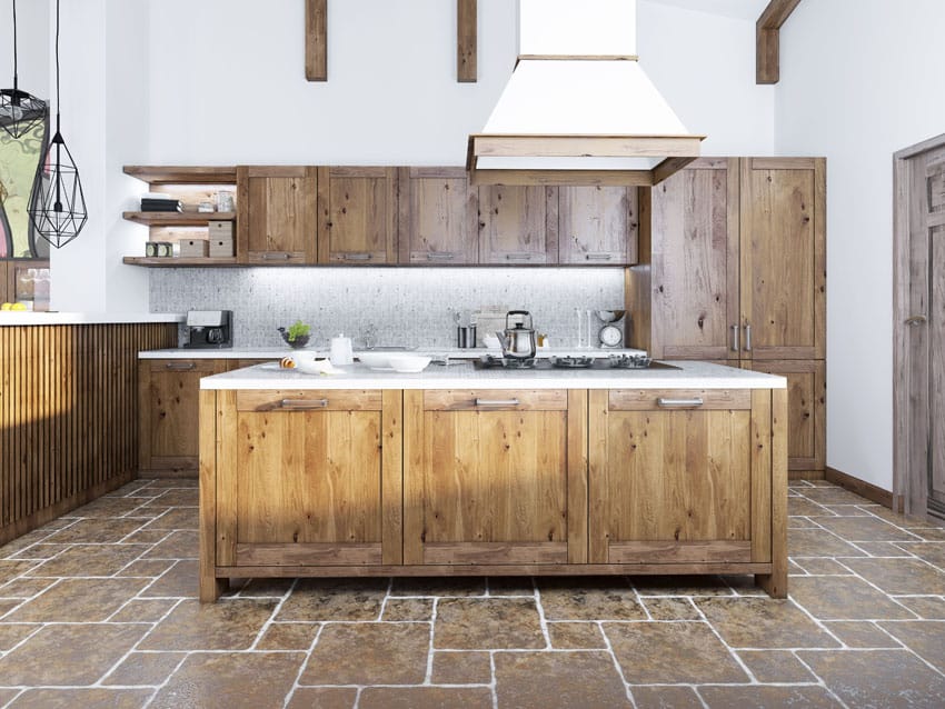 Kitchen with hopscotch patterned floors, exposed beam ceiling and white hood