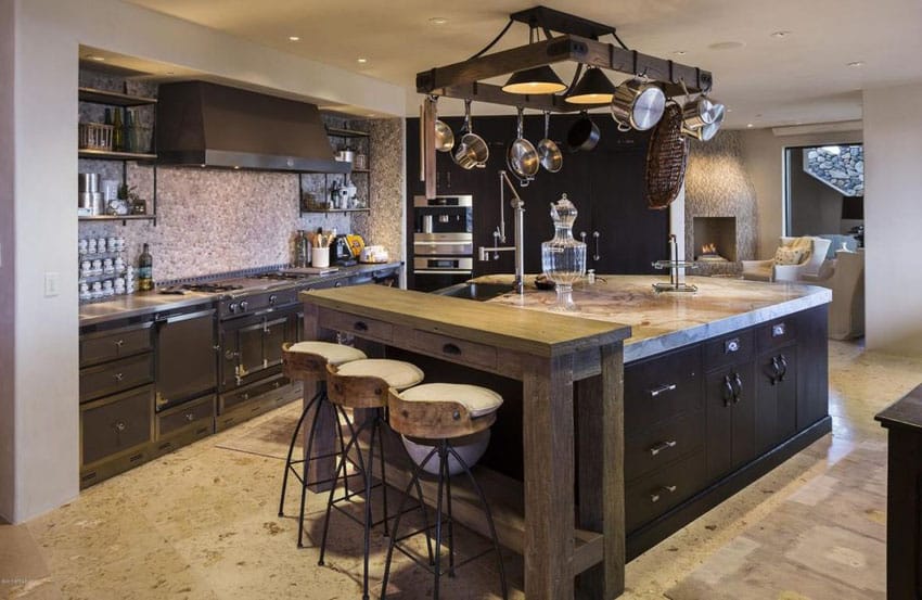 Rustic chefs kitchen with dark cabinets, wood breakfast bar and large island