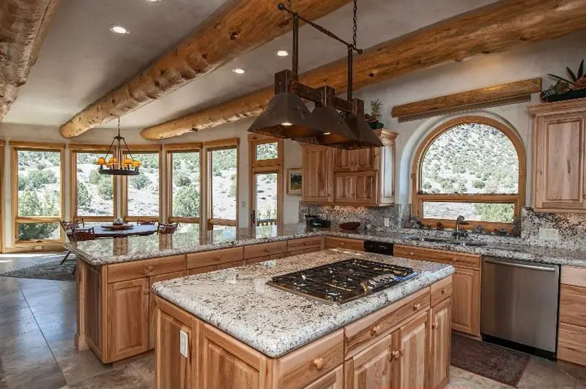 Kitchen with hickory cabinets, wood hardware pull knobs and andino white granite island countertops 