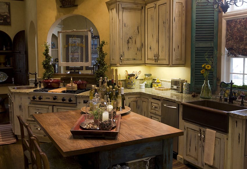 Rustic kitchen with copper farmhouse sink and distressed cabinetry