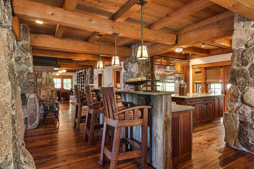 Kitchen with wood beams on the ceiling, wood floors and granite bar