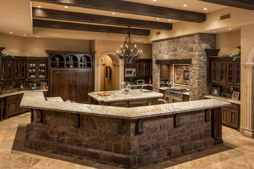 Rustic Mediterranean style kitchen with custom breakfast bar and betularie granite counters