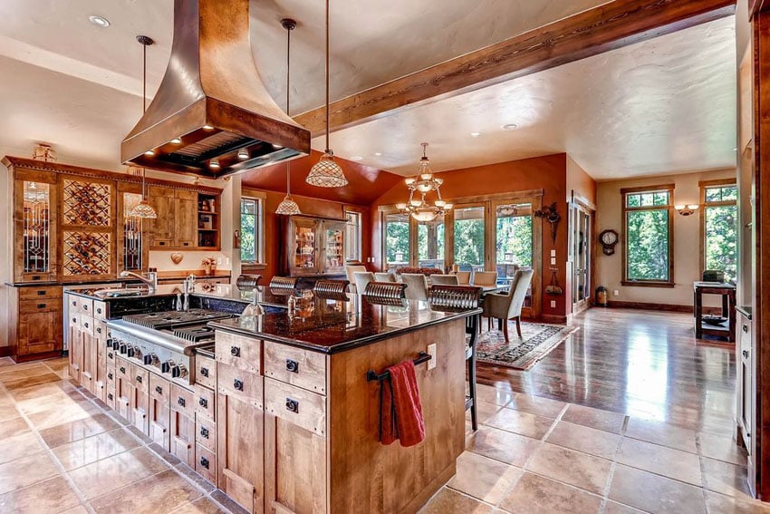 Rustic open concept kitchen with island range and custom cabinetry