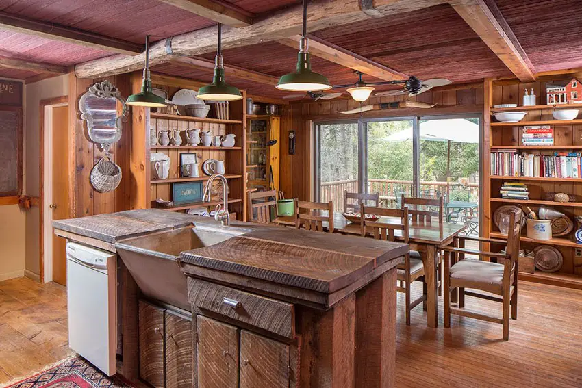 Kitchen with redwood island, steel wash basin, bookshelves and flush lighting 