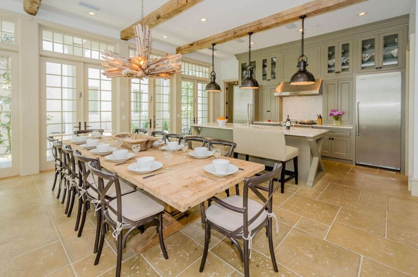 Kitchen with green cabinets, marble counter breakfast bar and open layout design