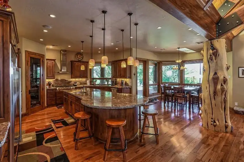 Kitchen with large decorative tree centerpiece custom island and maple floors