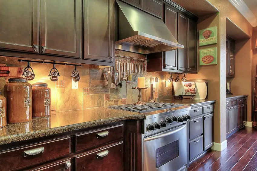 Ktchen with cabinetry in tan finish and track lights under the cabinets