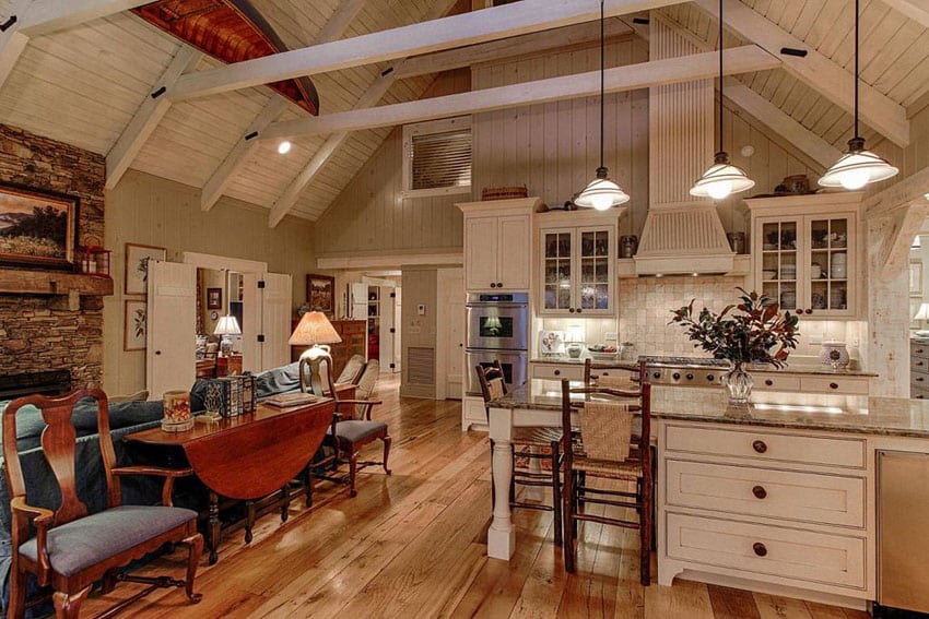 White country kitchen with hickory wood floors rustic island and cathedral ceiling